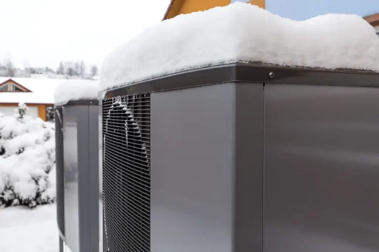 Heat pump thawing - Picture of 2 residential heat pumps covered in snow
